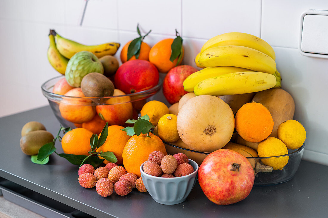 Collection of different fresh tasty ripe tropical fruits in bowls