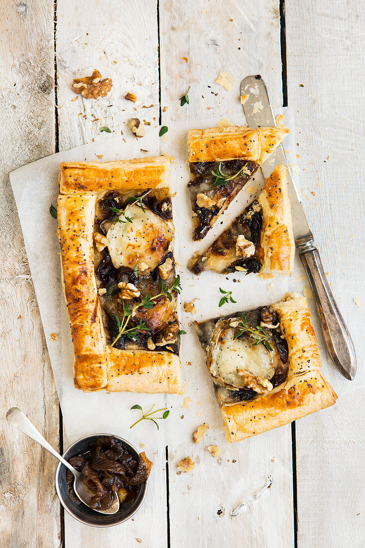Goat's cheese and caramelised onion tart topped with walnuts and thyme