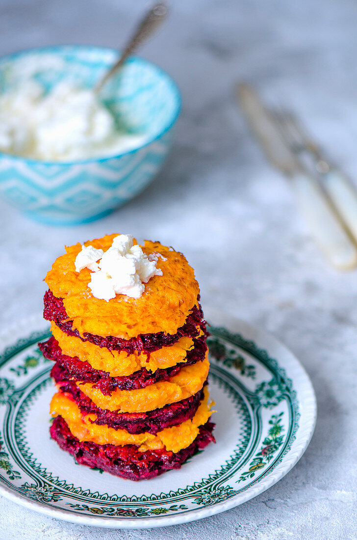 The stack of carrots and beets fritters with ricotta