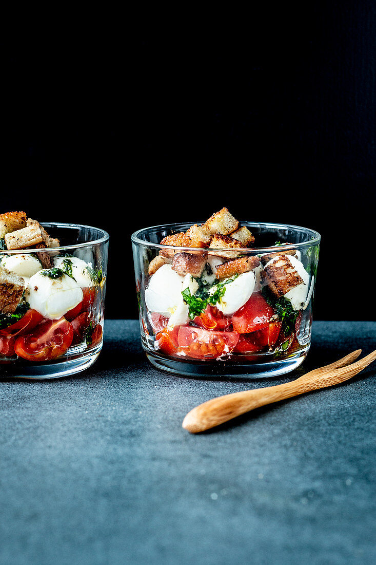Caprese salad with croutons in glasses