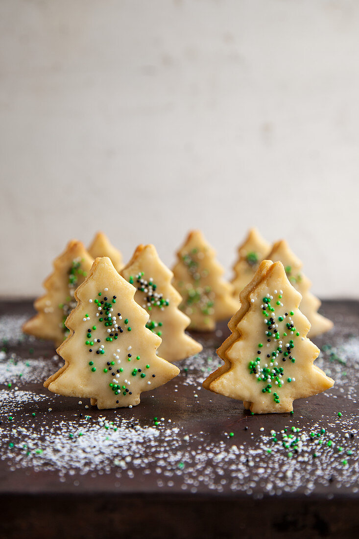 Iced Christmas tree biscuits decorated with sugar pearls