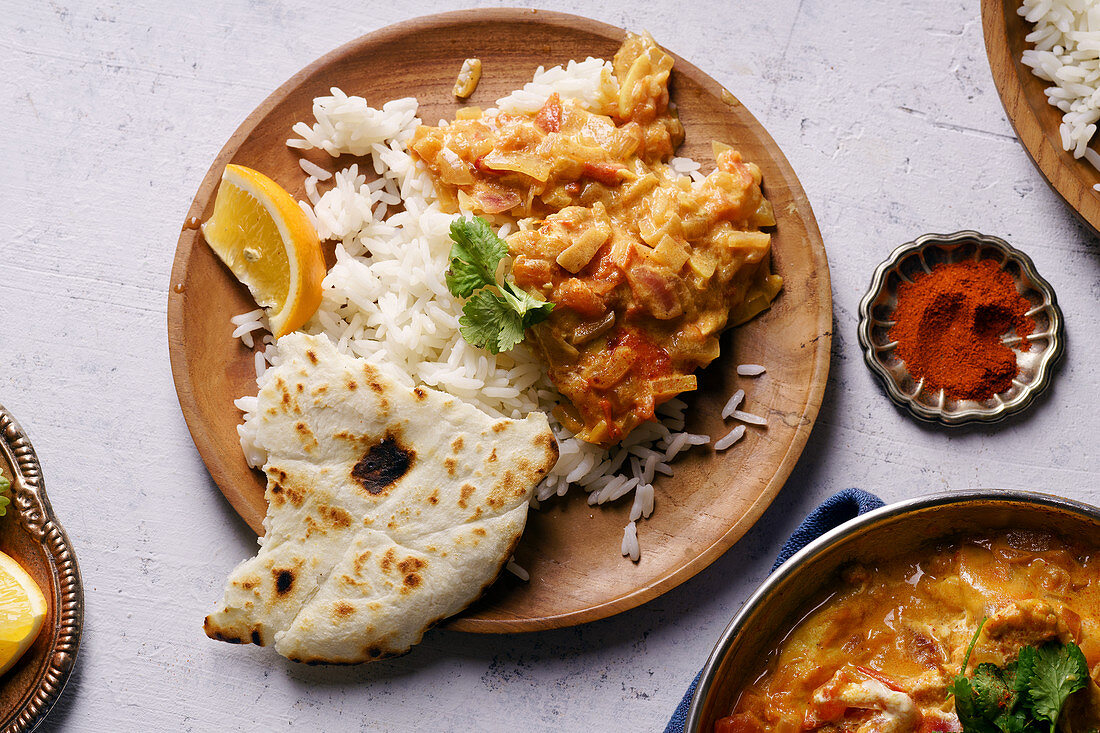 Indian chicken tikka masala with rice and naan bread