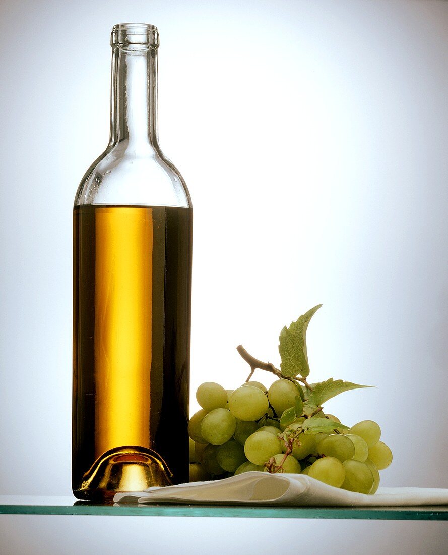 White Grape Juice in a Bottle with Grapes