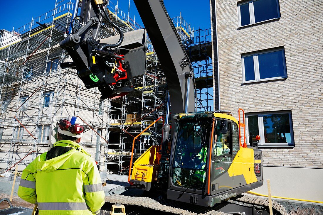 Construction worker on site with digger