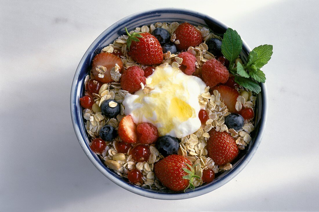 A Bowl of Muesli with Berries, Yogurt and Honey