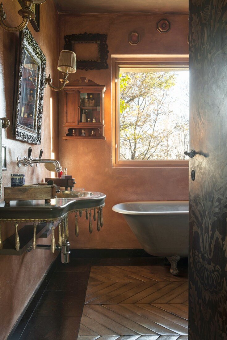 View through open door into vintage bathroom with historical ambiance