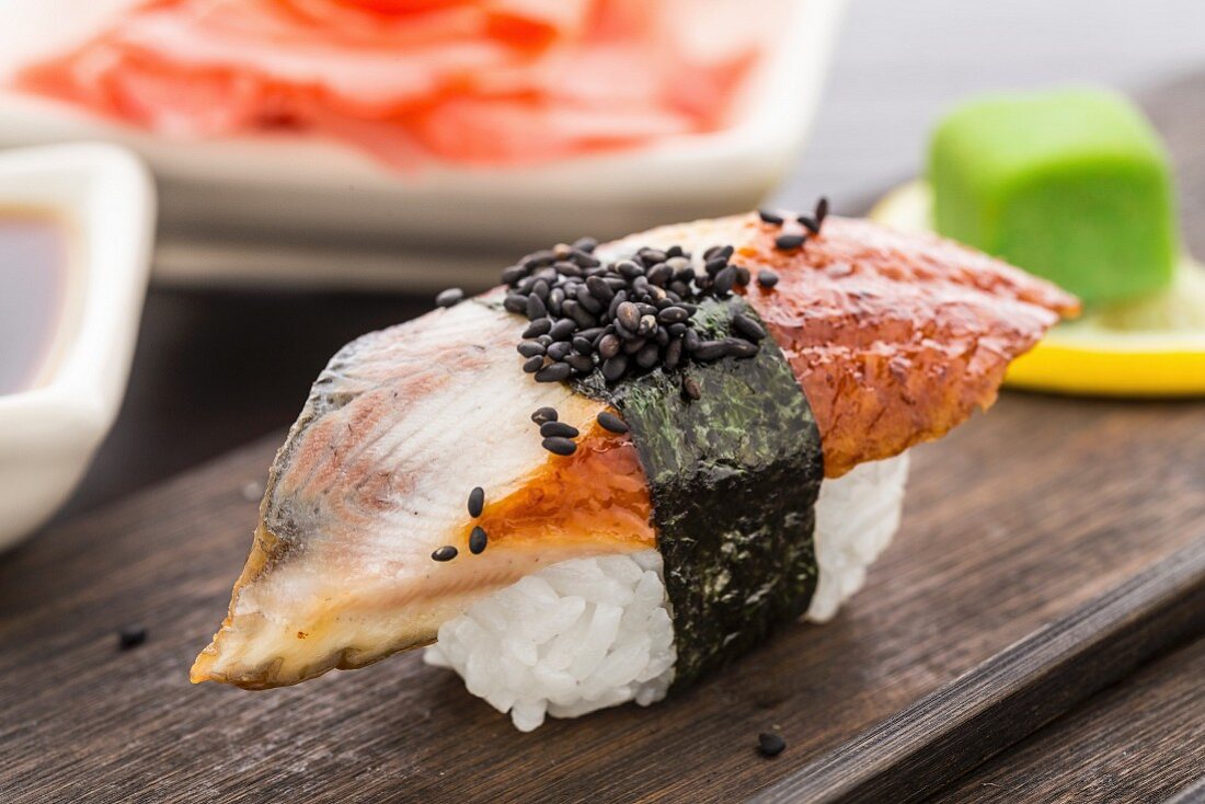 Nigiri-Sushi mit Räucheraal auf einer Holzplatte