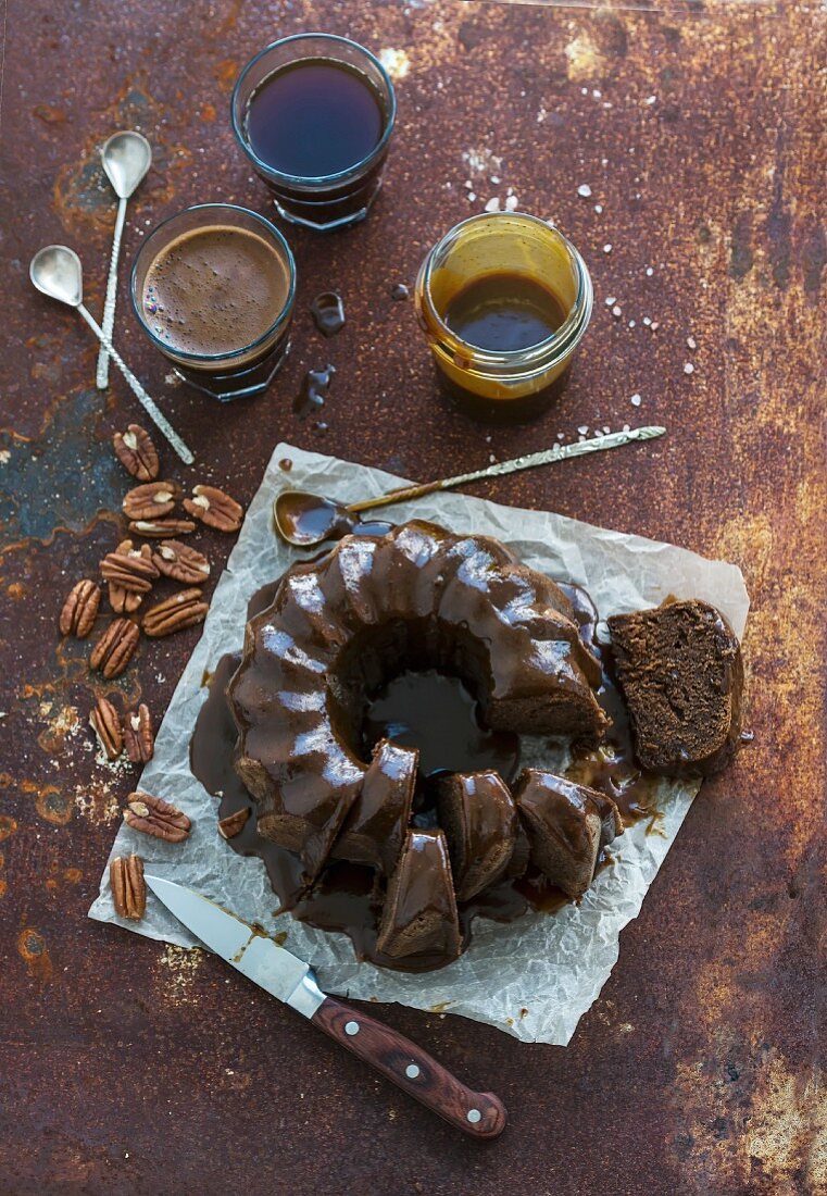 Chocolate coffee bundt cake with salt caramel icing over grunge rusty metal backdrop