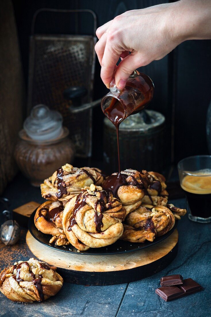 Swirl buns with a chocolate and cinnamon filling, chocolate sauce and walnuts