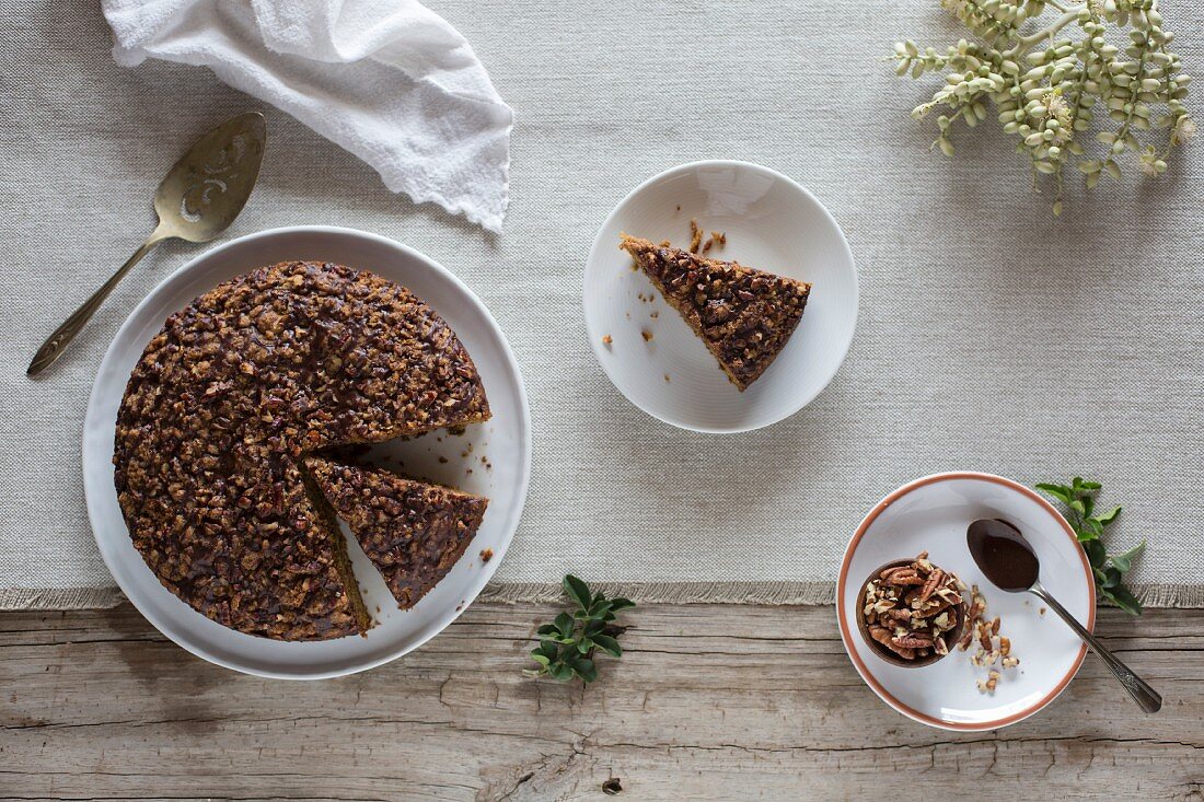 A slice of Pumpkin Coffee Cake with Cocoa Vanilla Glaze is served on a plate with the actual cake sliced