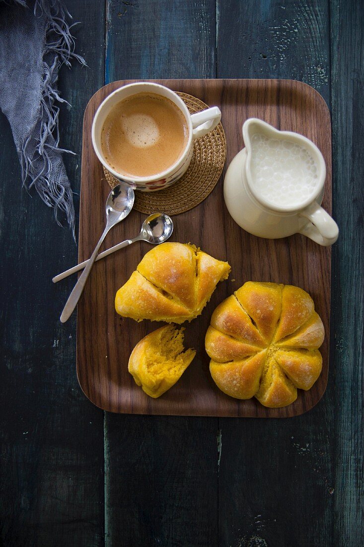 Mini pumpkin buns with coffee and a milk jug