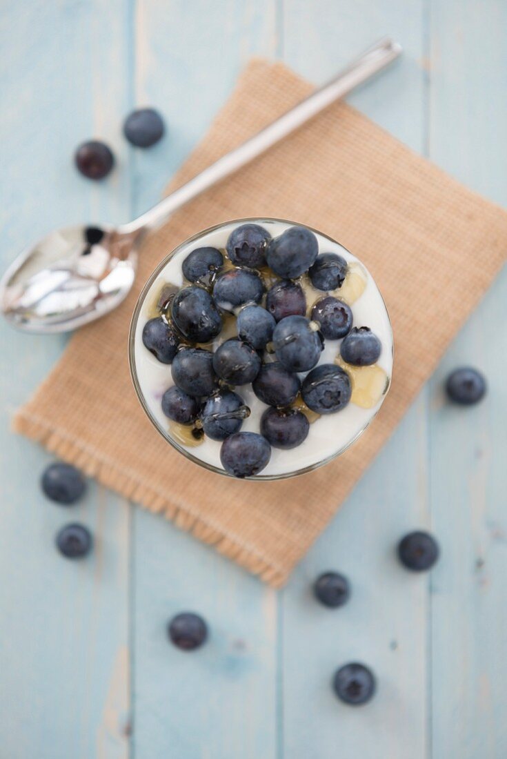 Blueberries in natural yoghurt with drizzled honey