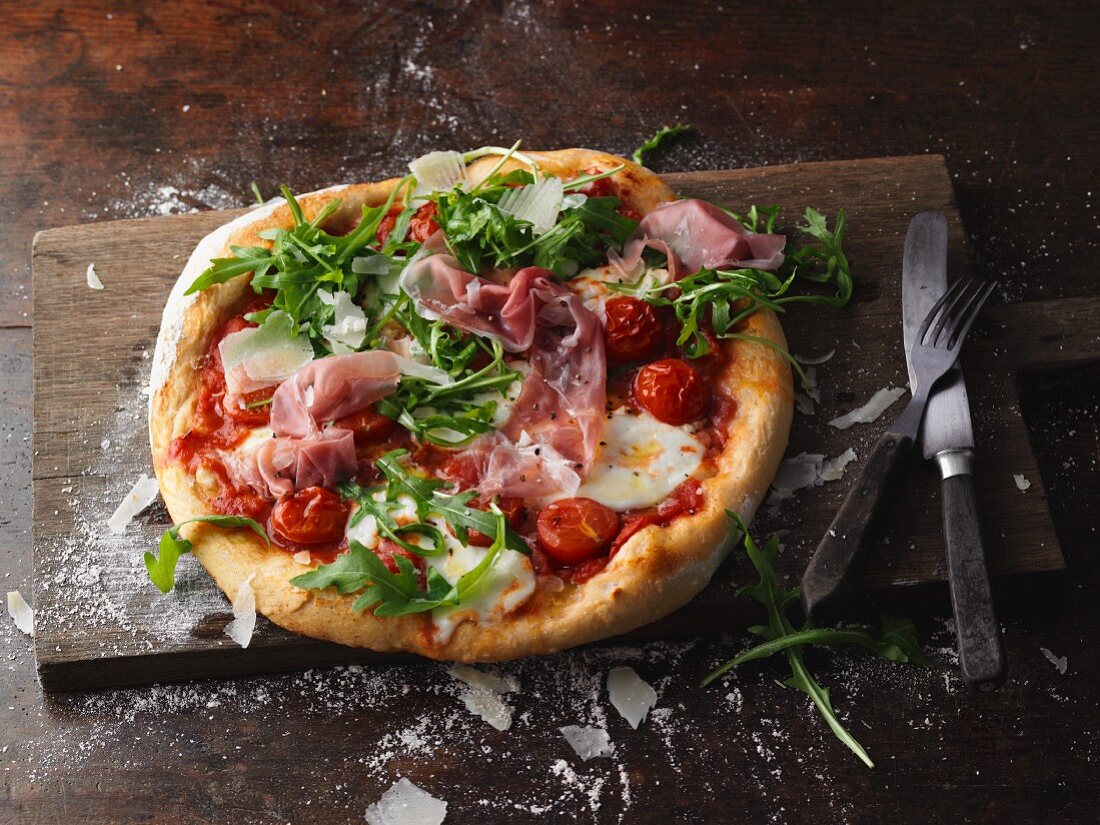 Pizza Parma with rocket and cherry tomatoes