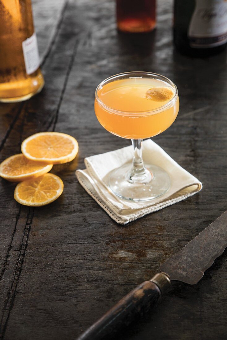 A champagne cocktail with orange garnish