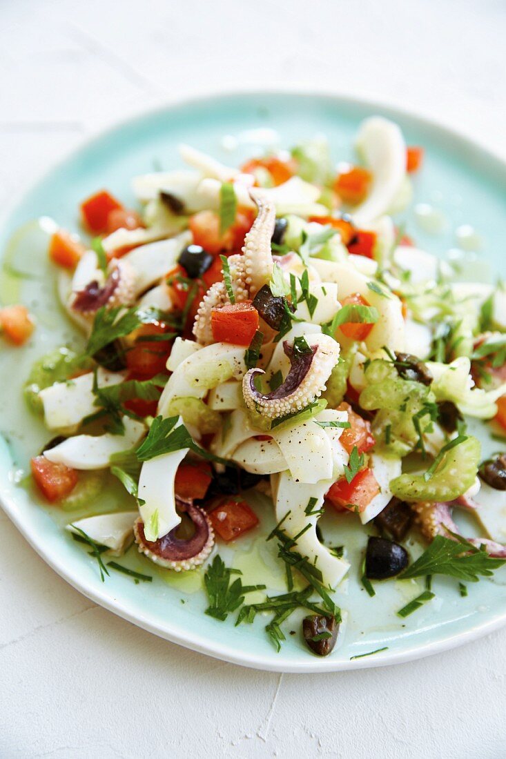 Octopus salad with celery, tomato and black olives