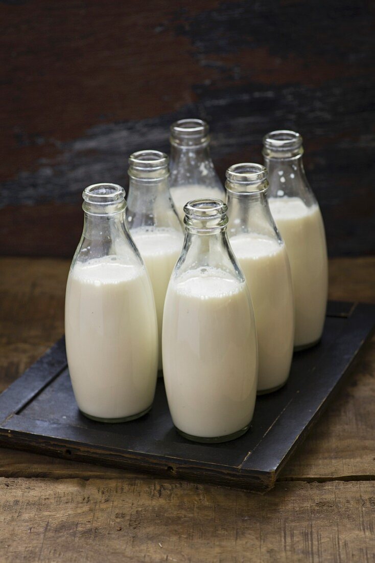 Milk in a bottles on wooden background