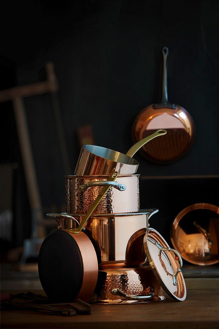 A stack of different copper pots