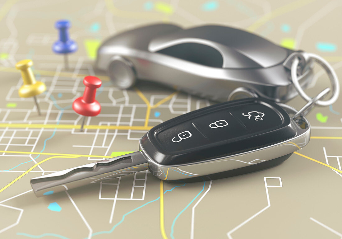 Car key and push pins in road map