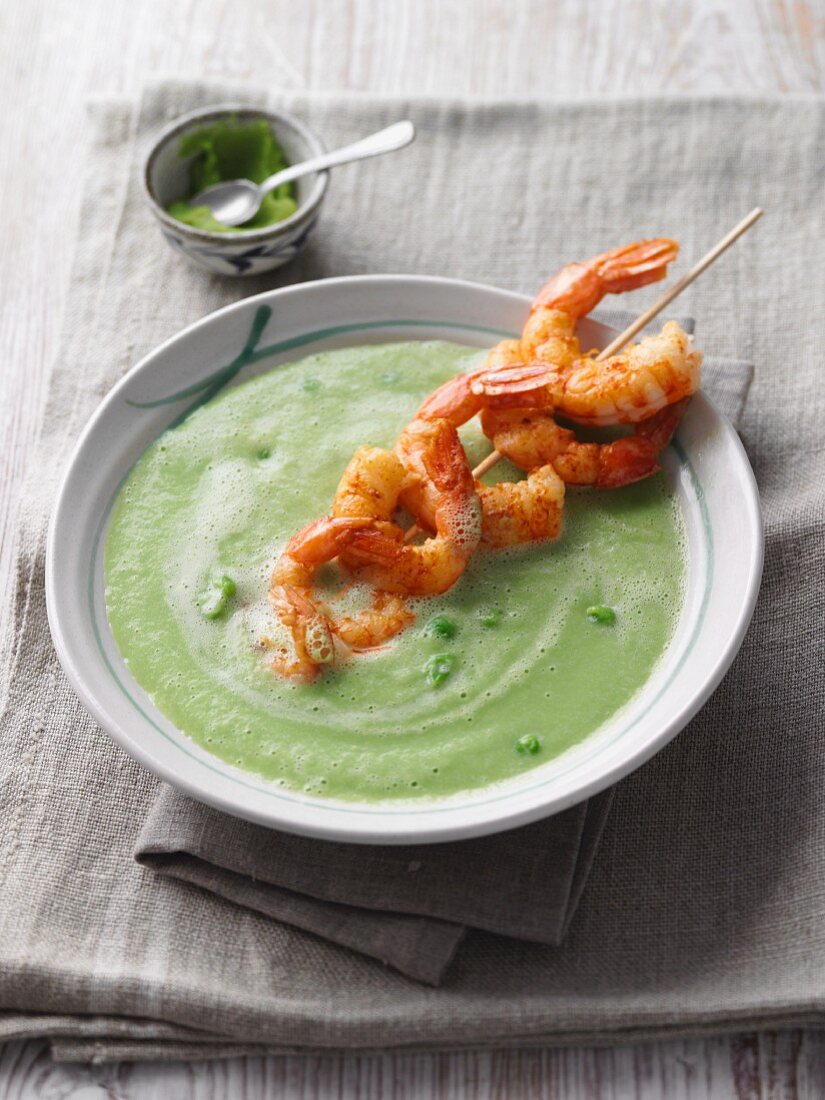 Pea and avocado soup with grilled prawn skewer