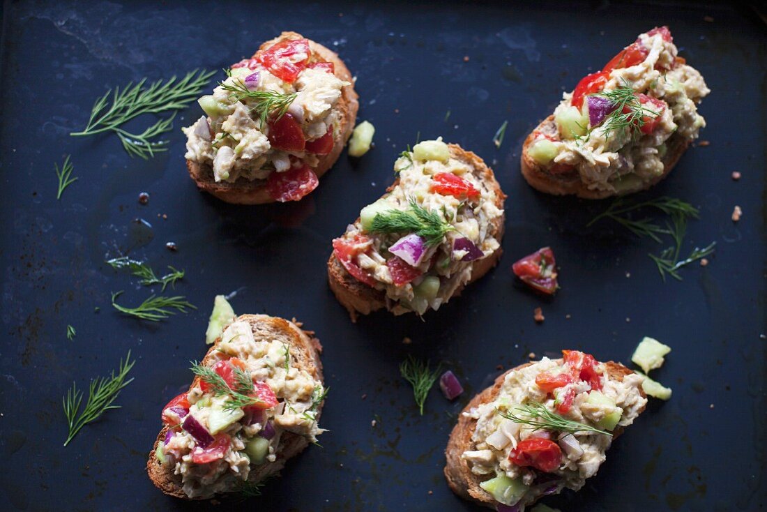 Chicken avocado salad with fresh dill on toast for a light lunch or appetizer