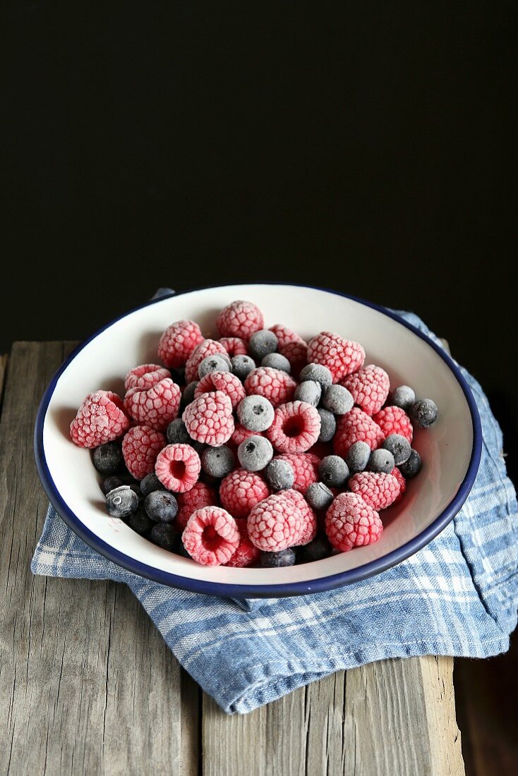 Frozen blueberries and raspberries in a bowl