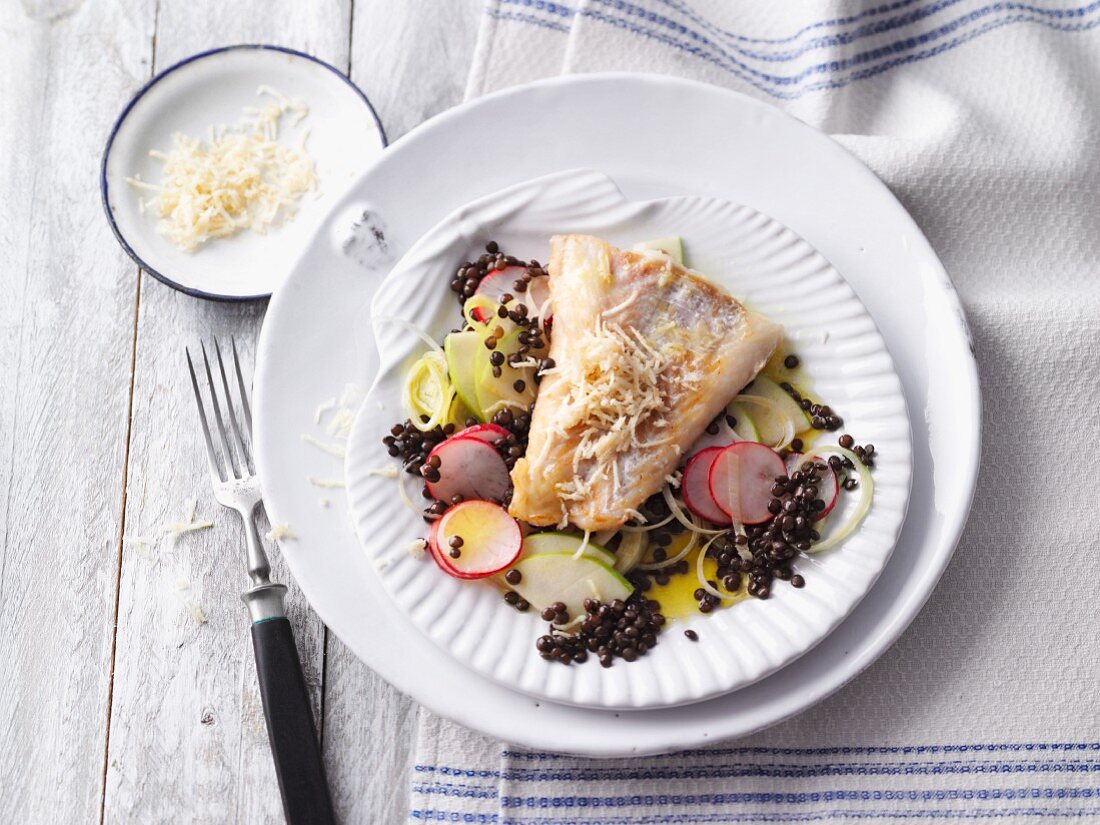 Cod on a bed of beluga lentils with apple and radishes