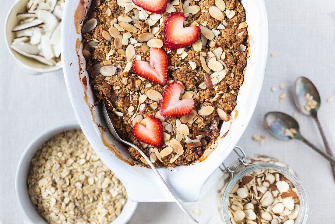 A large oval bowl of Strawberry and Rhubarb Breakfast Oat Crisp