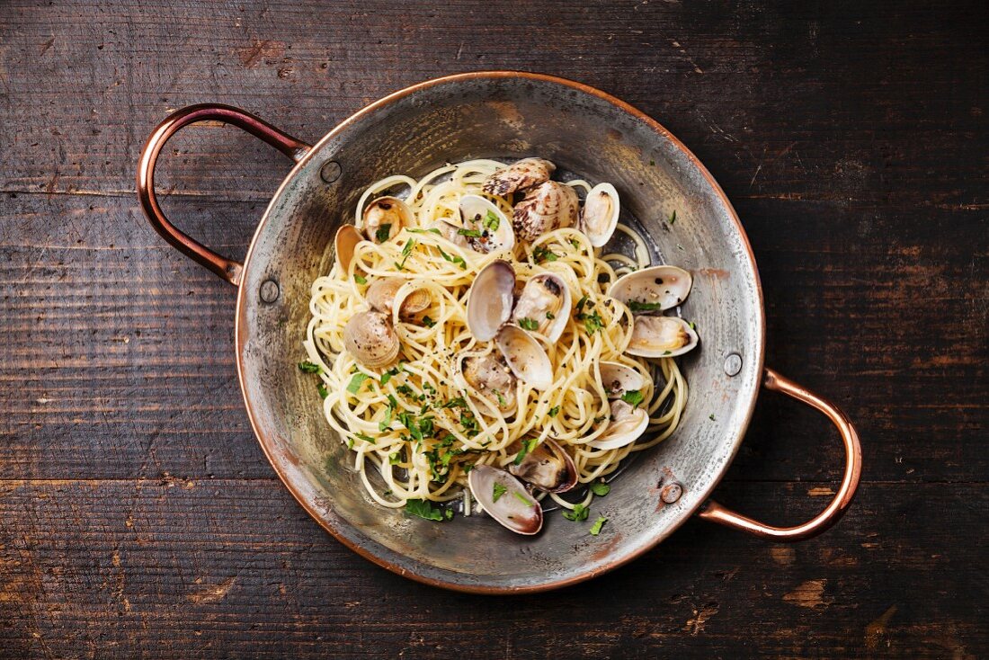 Seafood pasta with clams Spaghetti alle Vongole on wooden background