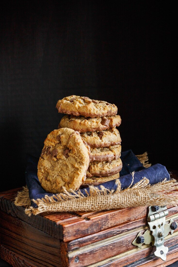 Stack of Chocolate chunk Cookies on a dark rustic background