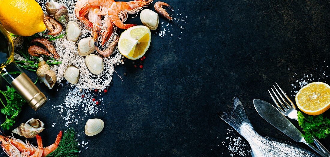 Delicious fresh fish and seafood on dark vintage background