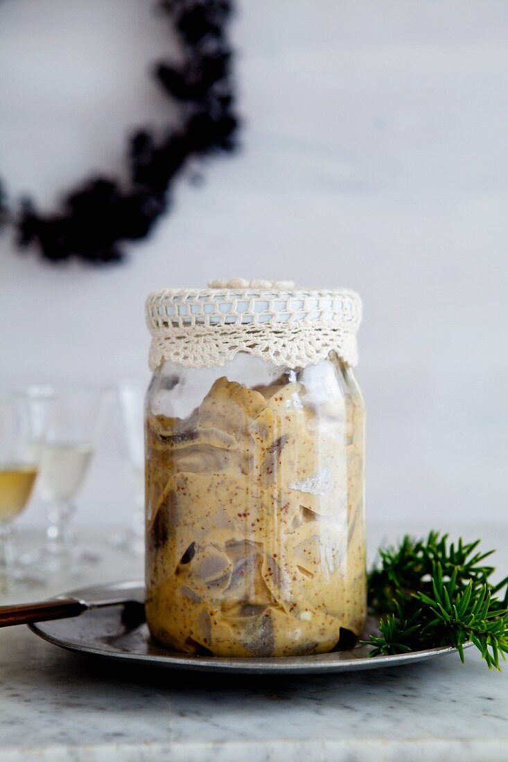 Pickled mustard herring in a glass jar for Christmas