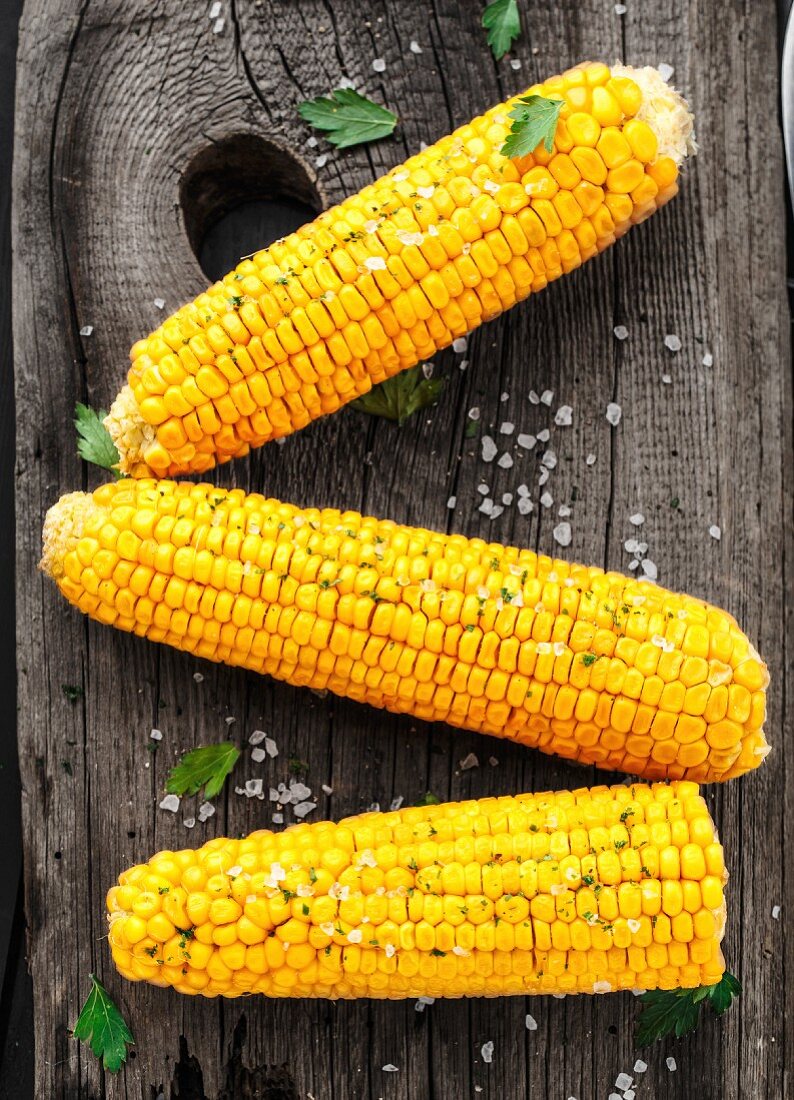 Delicious grilled corn on a wooden board