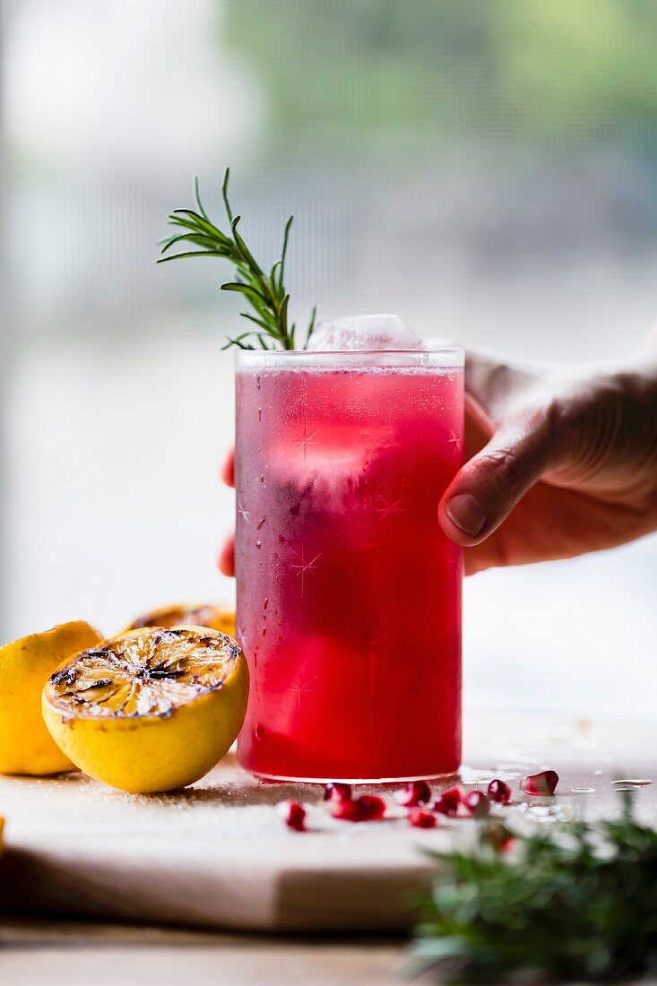 A pomegranate cocktail with rosemary