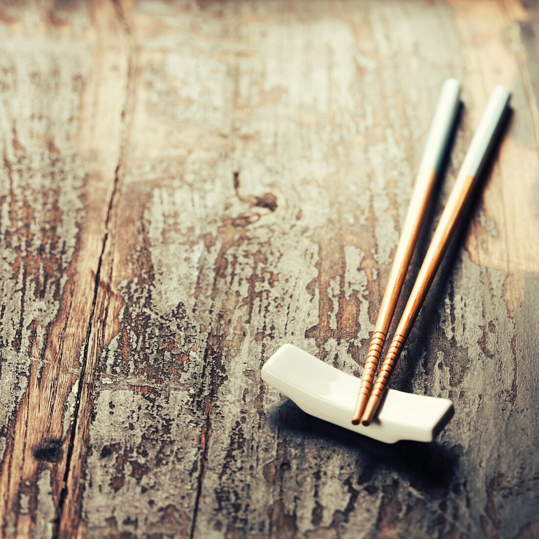 Pair of chopsticks on rustic wooden background