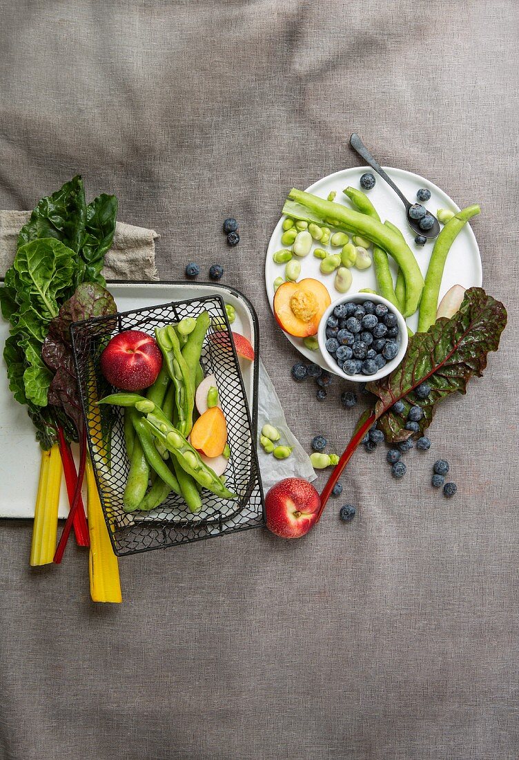 An arrangement of chard, broad beans, nectarines and blueberries