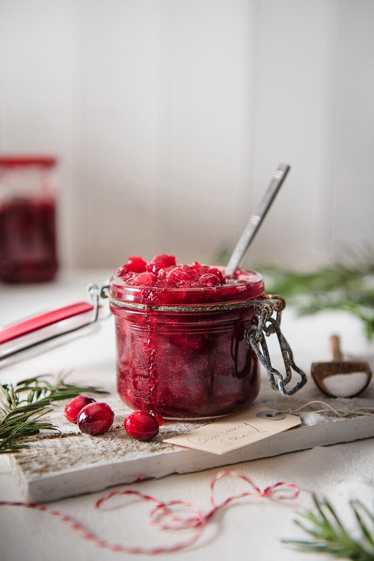 Homemade cranberry sauce in a storage jar