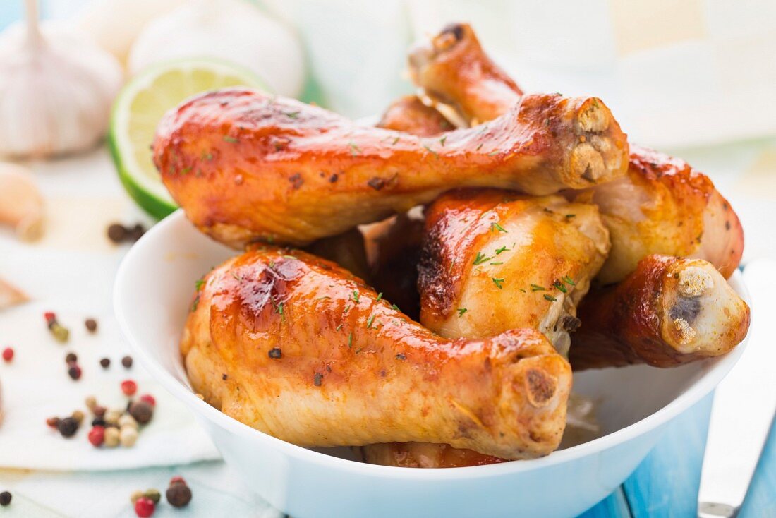 Delicious roasted chicken legs in a bowl