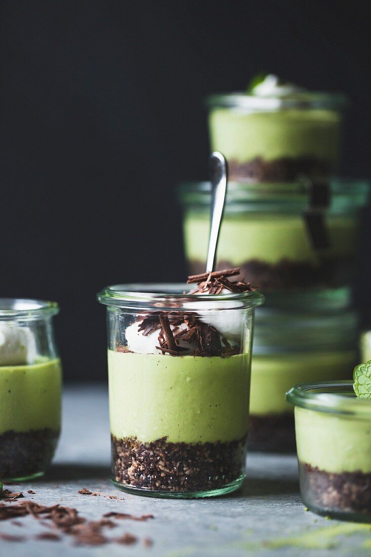 No-bake grasshopper pies with matcha tea and chocolate sprinkles in glass jars