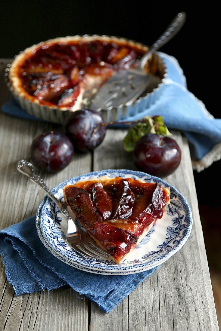 Slice of plum tart on a plate