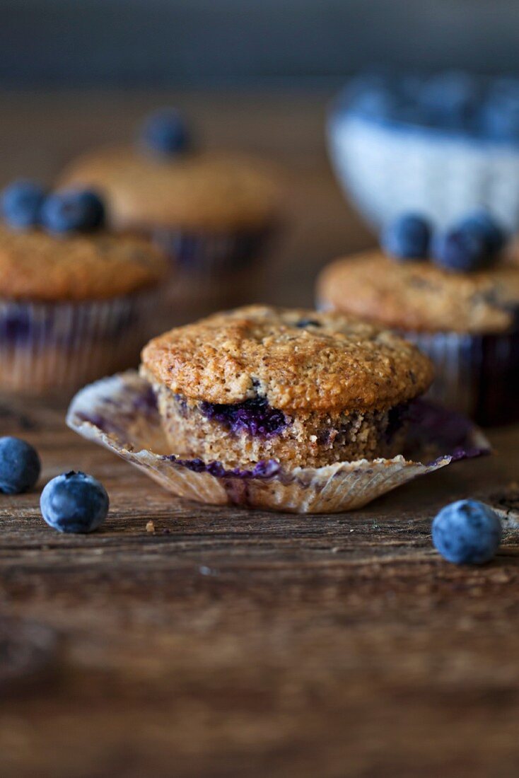 Freshly baked Blueberry hazelnut muffins on a rustic wooden table