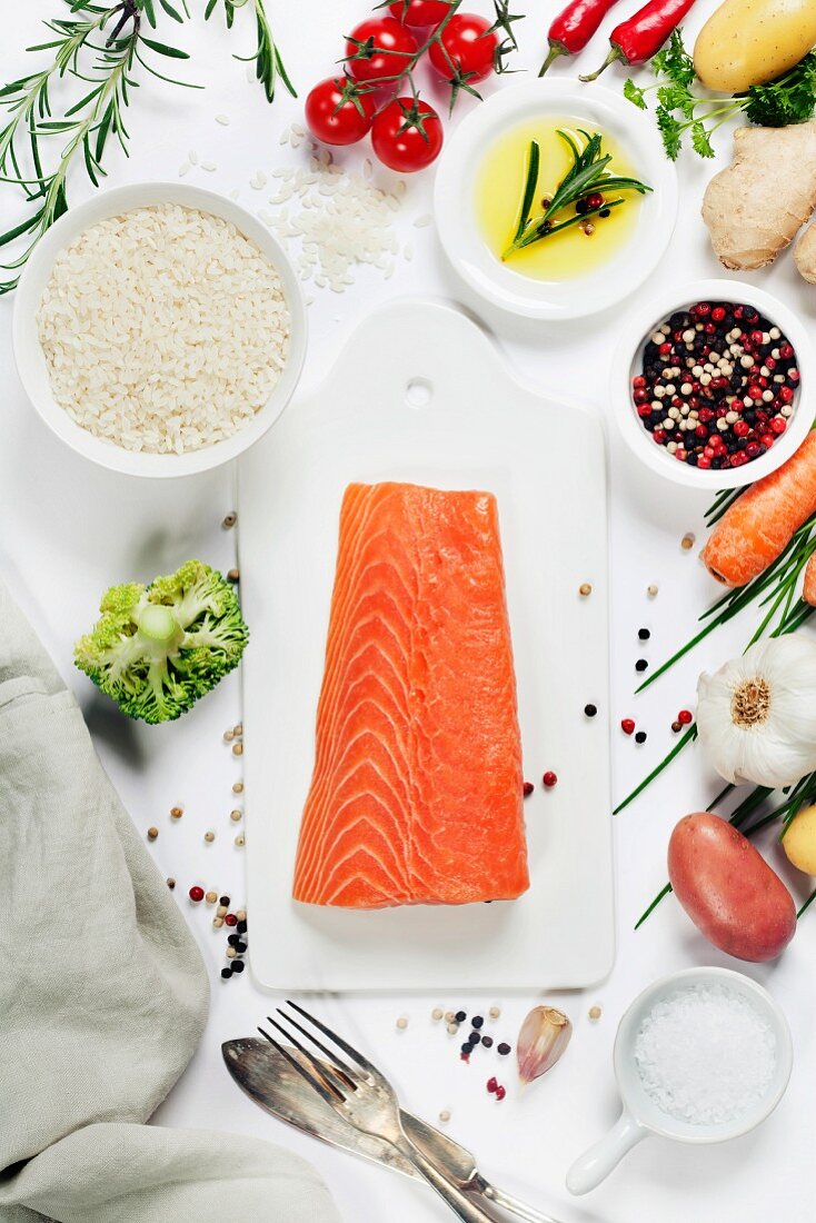 Delicious portion of fresh salmon fillet with aromatic herbs, spices and vegetables