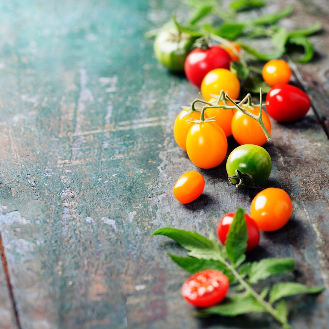 Various of colorful tomatoes on wooden background