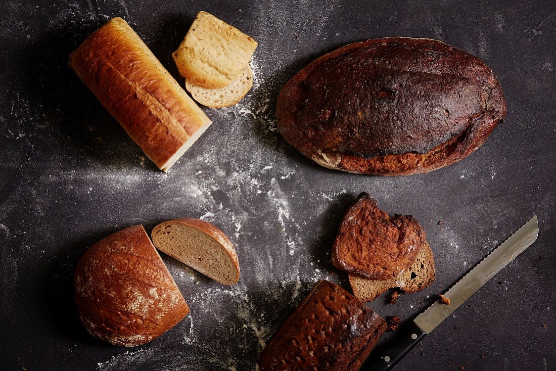 Various types of bread, some sliced