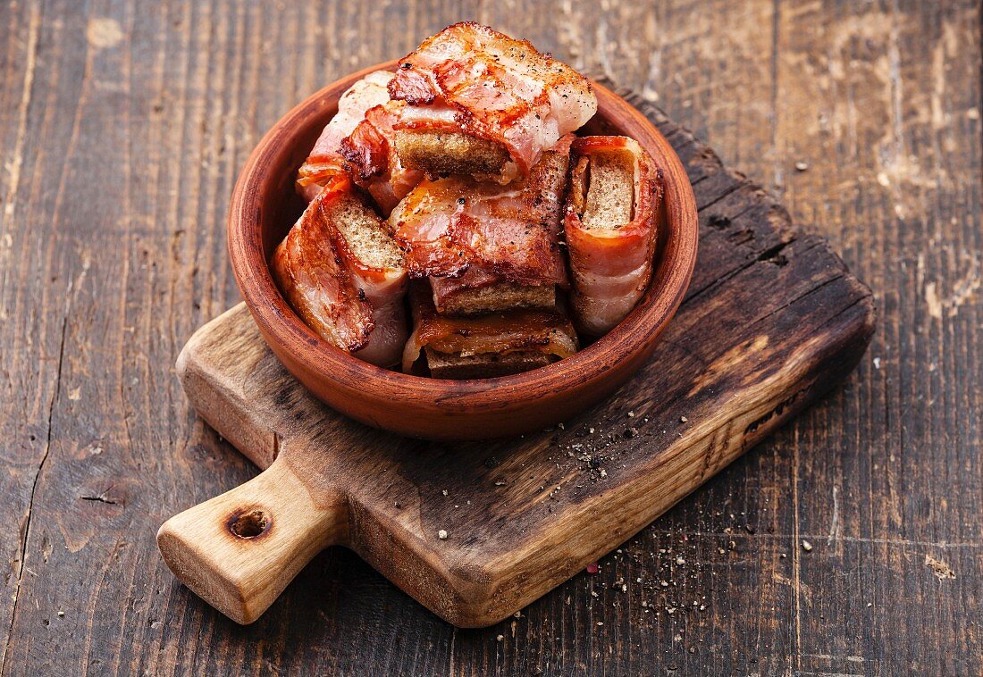 Appetizer bread slices fried in bacon