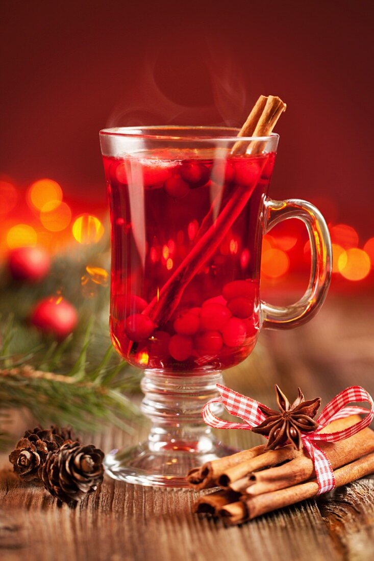 Hot mulled wine with berries, cinnamon sticks and anise