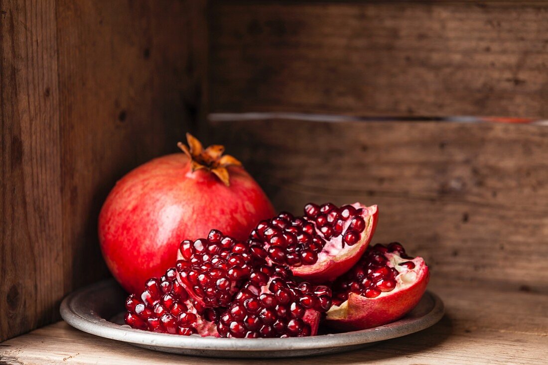 Whole pomegranate and pieces of pomegranate