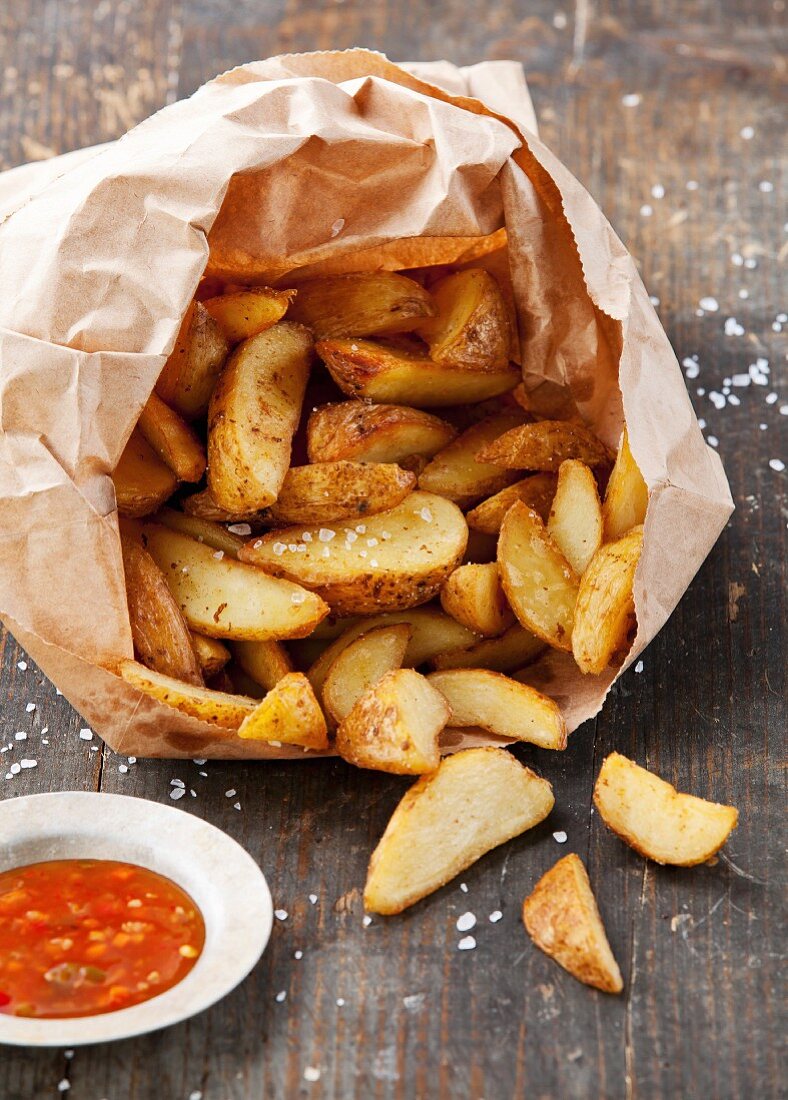 Fried potato country-style in paper bag