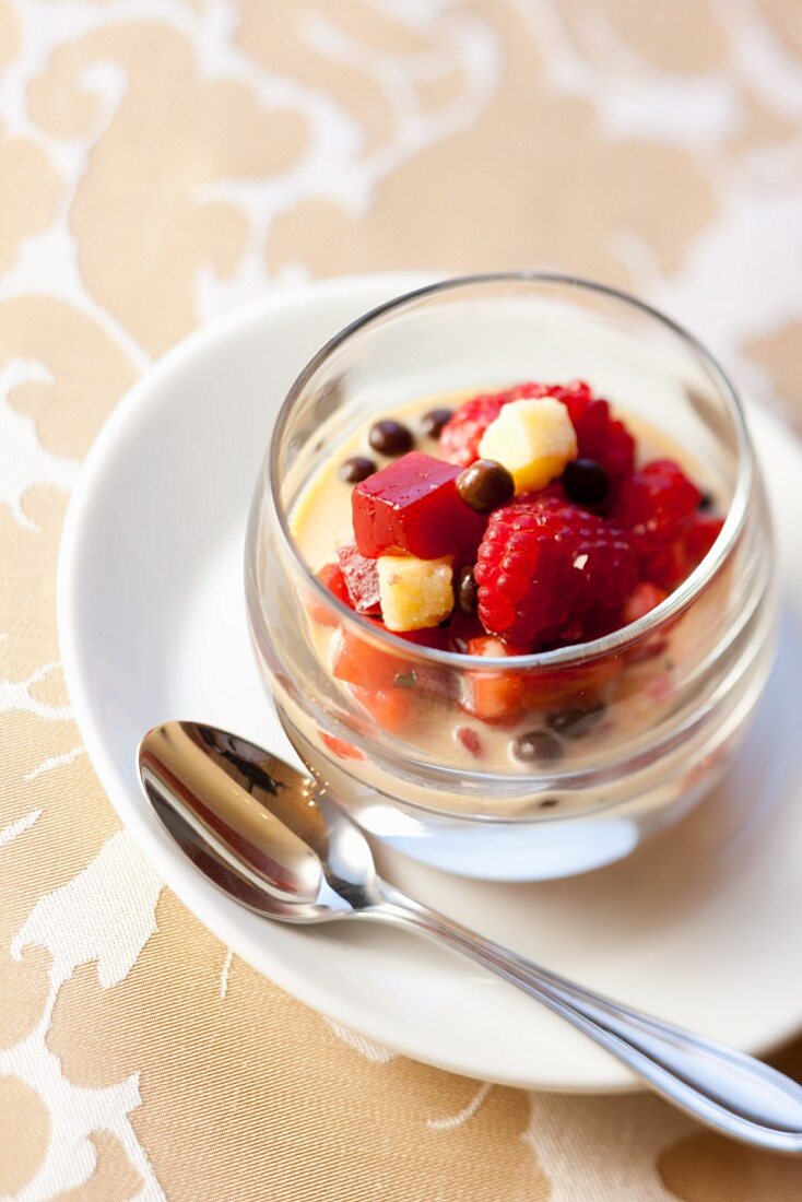 Vanilla cream with fruit salad and chocolate balls