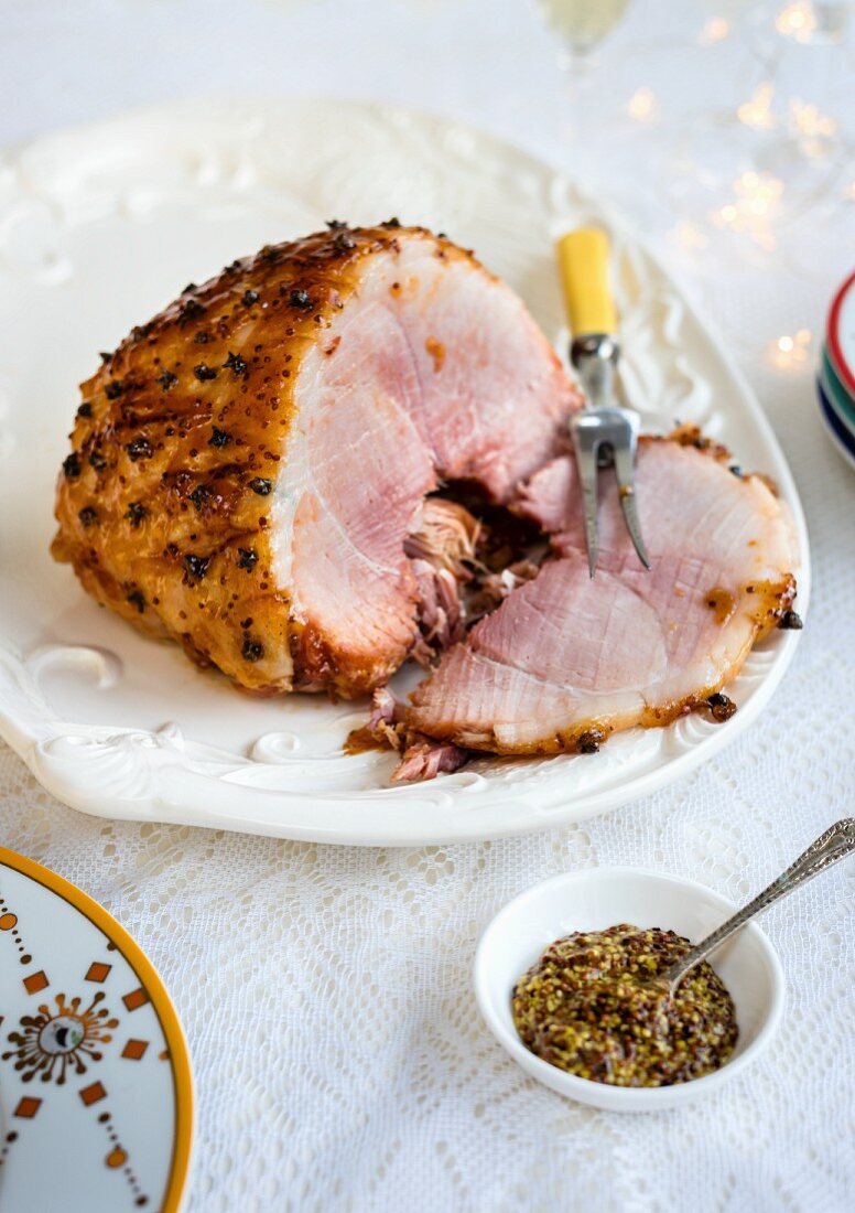 Glazed ham and coarse mustard garnished with carnations