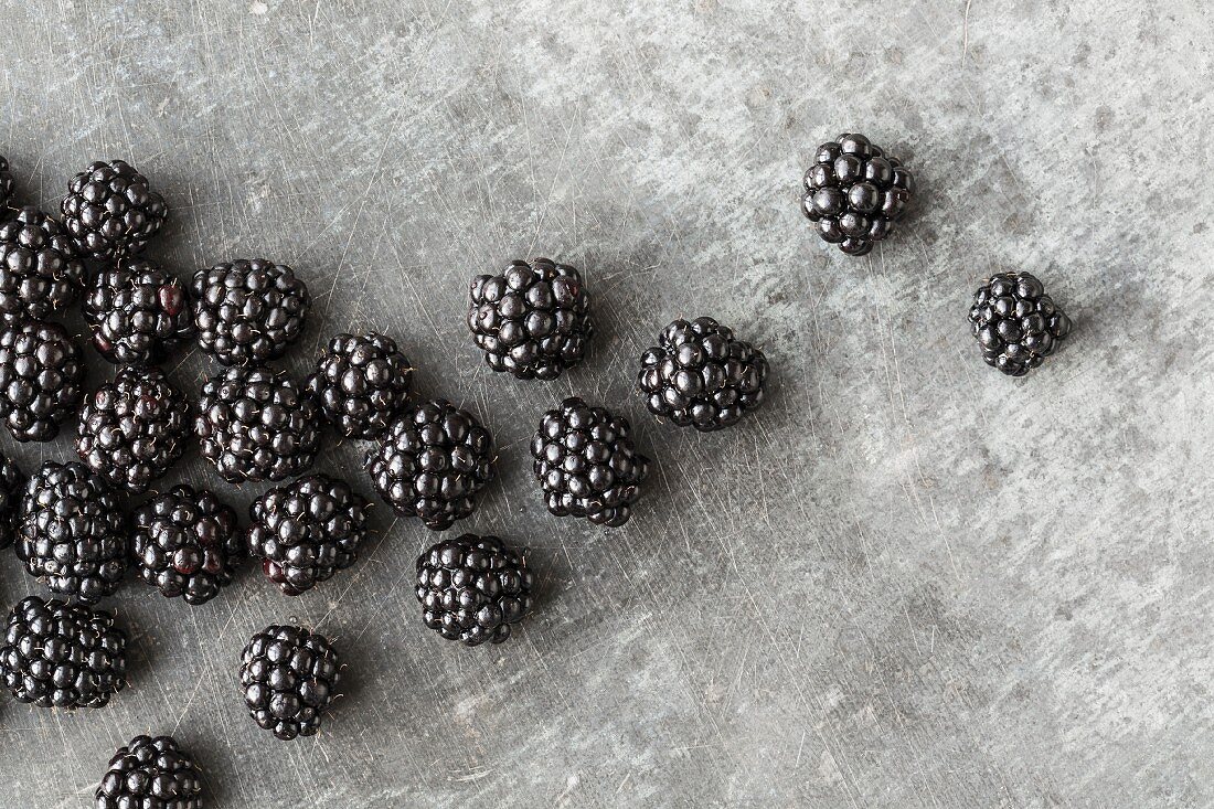 Blackberries on a grey metal surface